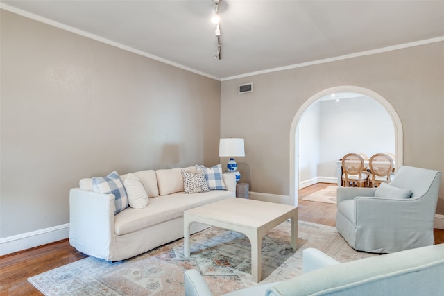 living room with ornamental molding and hardwood / wood-style floors