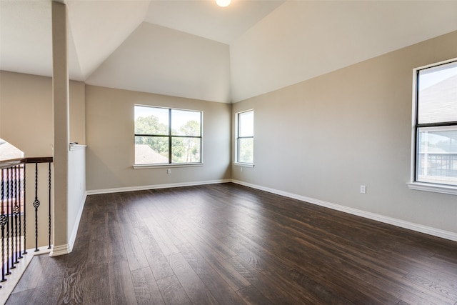 unfurnished room with lofted ceiling and dark hardwood / wood-style floors