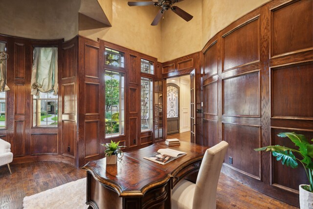 office area with a high ceiling and dark hardwood / wood-style flooring