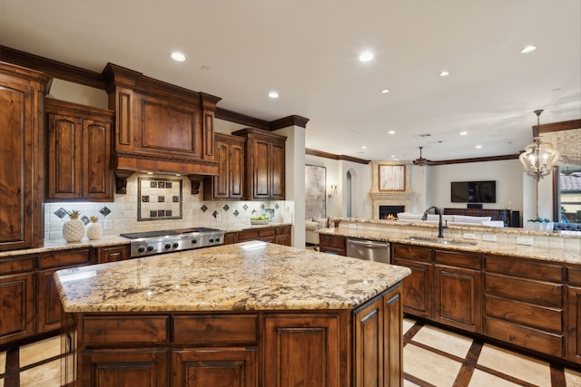 kitchen featuring stainless steel appliances, tasteful backsplash, a kitchen island, and sink