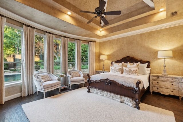 bedroom featuring a raised ceiling, multiple windows, ceiling fan, and dark hardwood / wood-style floors