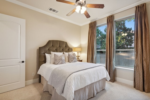 carpeted bedroom with crown molding and ceiling fan