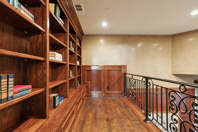 wine cellar with dark hardwood / wood-style flooring