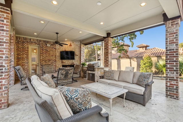 view of patio with exterior kitchen, an outdoor living space with a fireplace, a grill, and ceiling fan