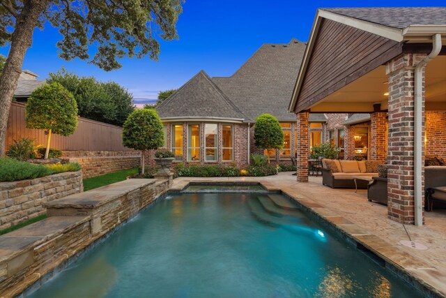 view of patio with grilling area, an outdoor living space with a fireplace, and an outdoor kitchen