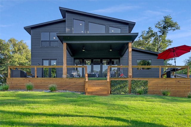 back of property featuring a yard and ceiling fan