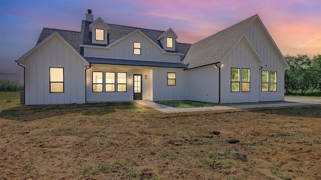 view of back house at dusk