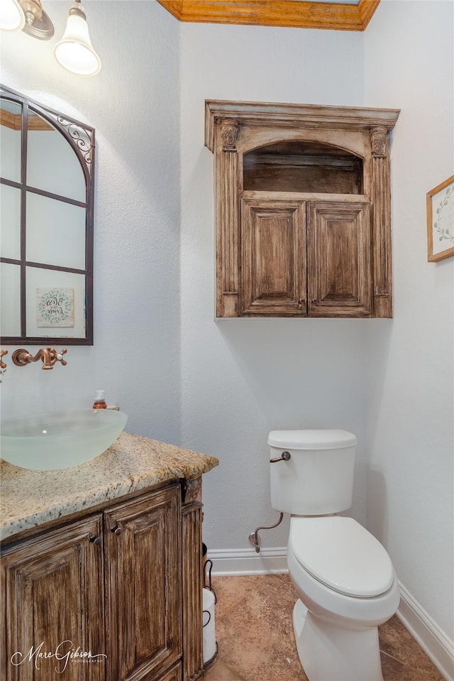 bathroom featuring toilet, vanity, ornamental molding, and tile patterned flooring