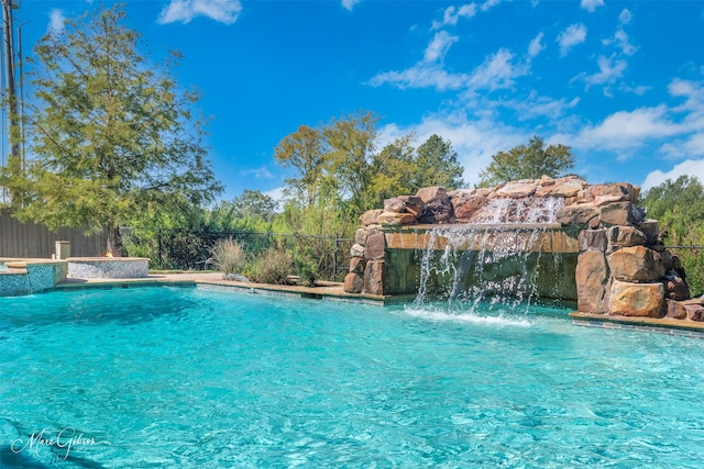 view of pool with pool water feature