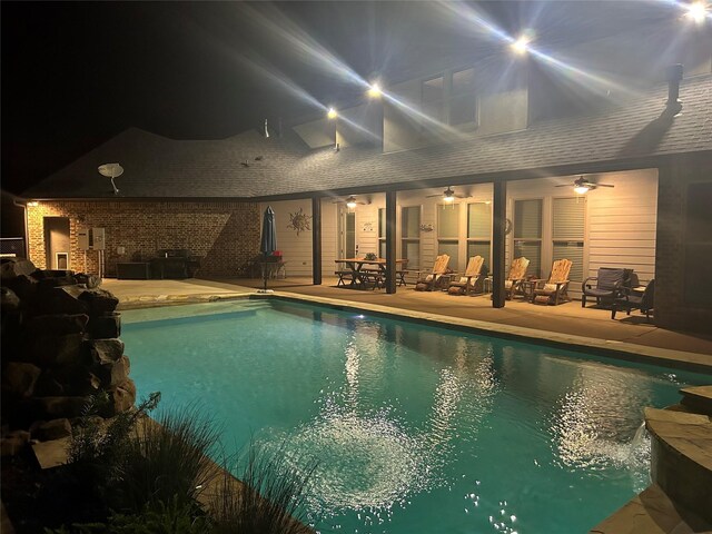 view of swimming pool with ceiling fan and a patio