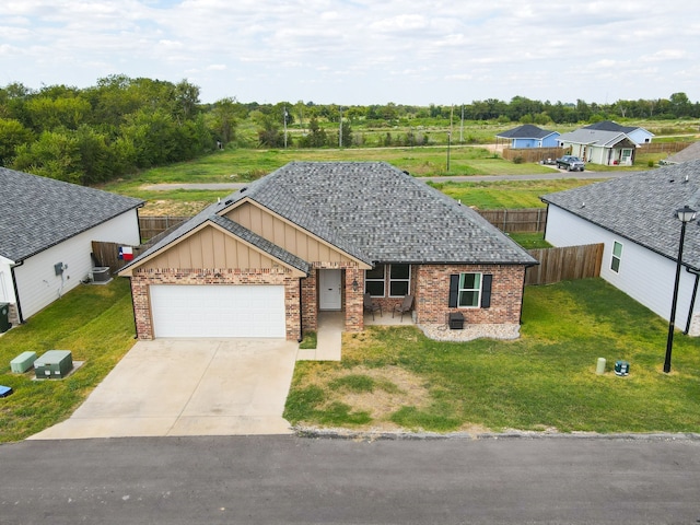 ranch-style house with a garage, a front yard, and central air condition unit