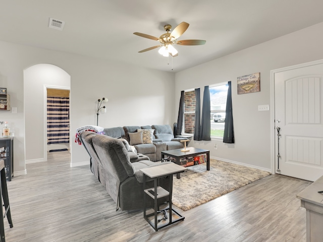 living room featuring ceiling fan and light wood-type flooring