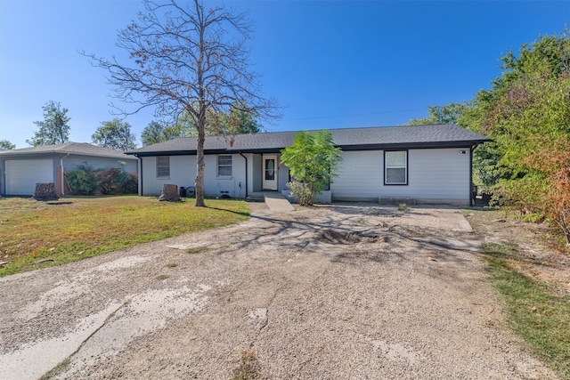 ranch-style home with a front lawn and a garage