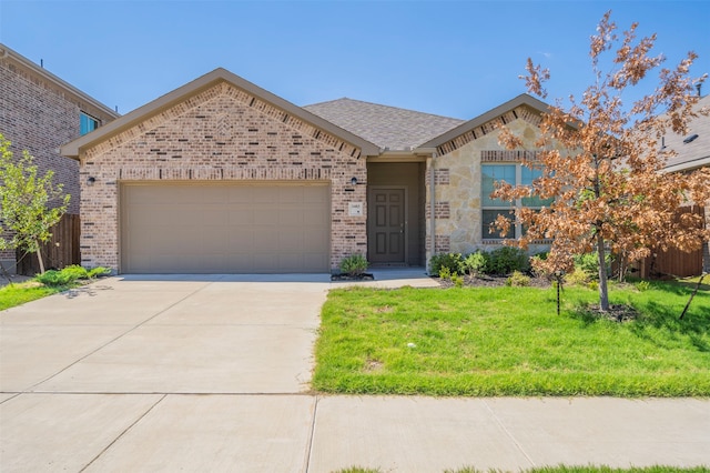 view of front of property featuring a garage and a front yard