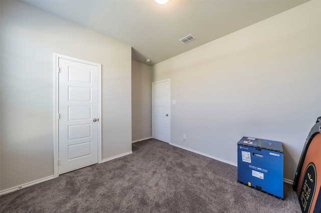 interior space with lofted ceiling and dark carpet