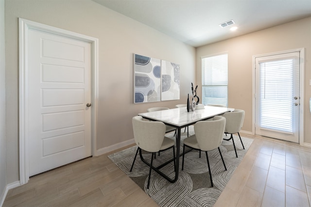 dining space with a wealth of natural light and light hardwood / wood-style flooring