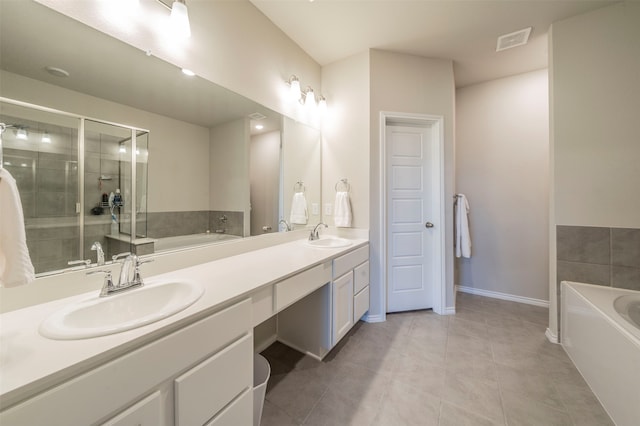 bathroom featuring tile patterned flooring, vanity, and plus walk in shower