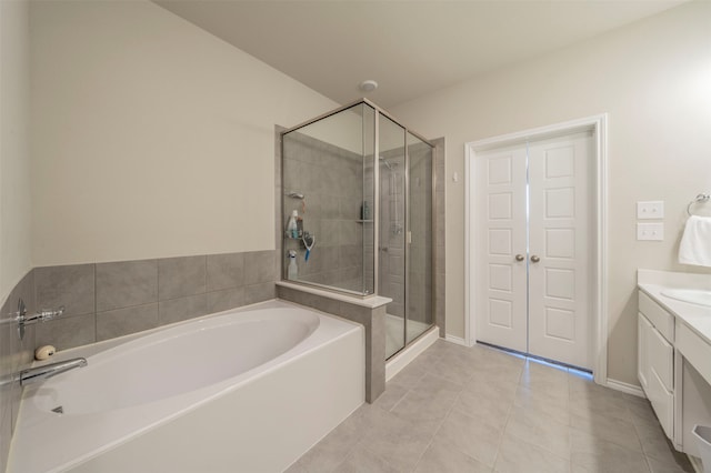 bathroom featuring tile patterned floors, shower with separate bathtub, and vanity