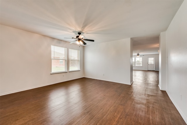 empty room with dark wood-type flooring and ceiling fan