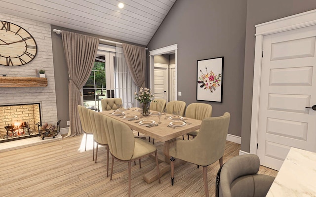 dining space featuring light wood-type flooring, a large fireplace, wood ceiling, and vaulted ceiling