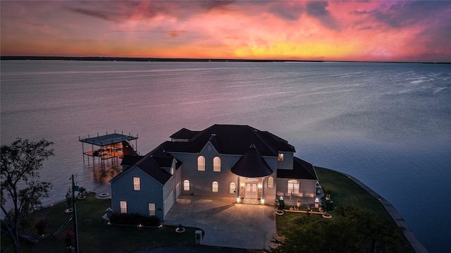 aerial view at dusk with a water view