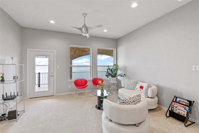 carpeted living room featuring ceiling fan