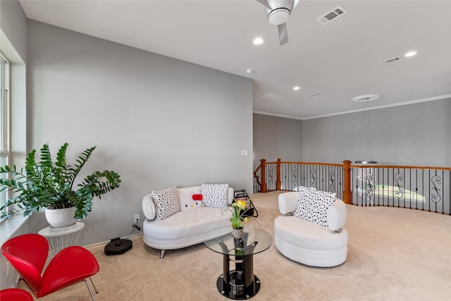 carpeted living room featuring ceiling fan and crown molding