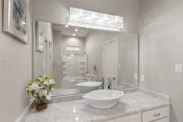 bathroom featuring walk in shower and vanity