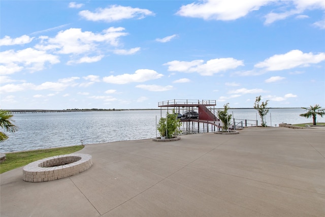 property view of water with an outdoor fire pit