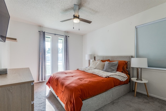 bedroom with ceiling fan, carpet, and a textured ceiling