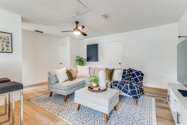 living room featuring ceiling fan and light hardwood / wood-style floors