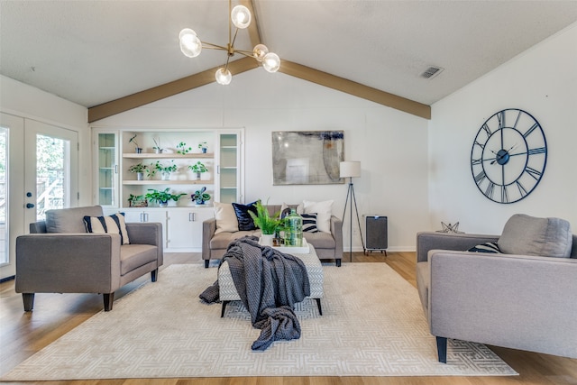 living room with french doors, light hardwood / wood-style floors, a notable chandelier, and vaulted ceiling with beams