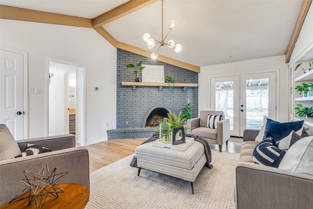 living room with an inviting chandelier, a fireplace, light hardwood / wood-style flooring, french doors, and lofted ceiling with beams