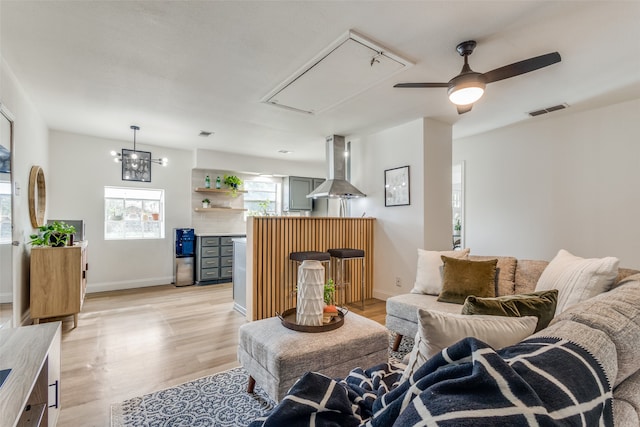 living room featuring light wood-type flooring and ceiling fan