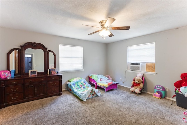 bedroom with a textured ceiling, ceiling fan, and light colored carpet