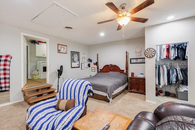 bedroom featuring ceiling fan, washer / clothes dryer, a closet, light colored carpet, and ensuite bathroom