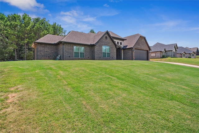 view of front of house with a front yard and a garage