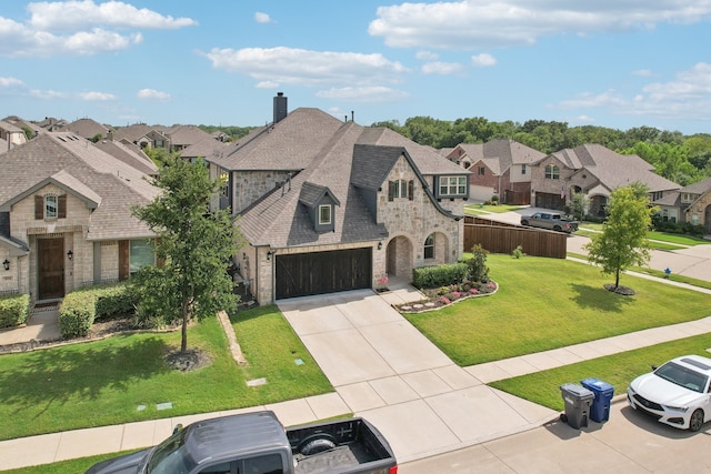 view of front of property featuring a garage and a front lawn