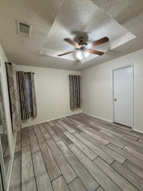 2413 Markland St, Irving, TX 75060 - unfurnished room with ceiling fan, light wood-style flooring, a textured ceiling, and baseboards