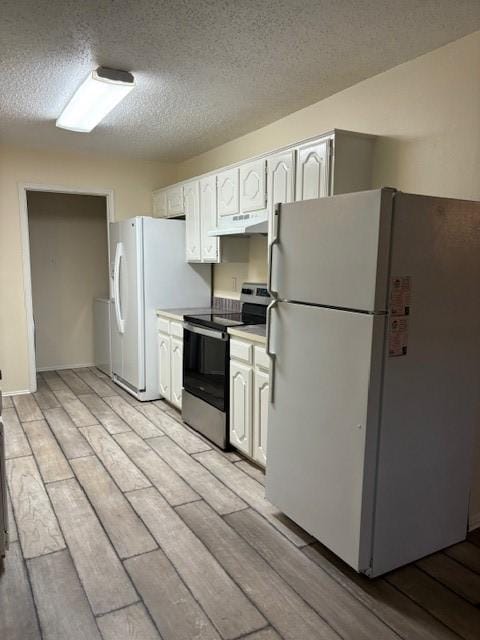 2413 Markland St, Irving, TX 75060 - kitchen with freestanding refrigerator, stainless steel electric range, a textured ceiling, light wood-style flooring, and white cabinets