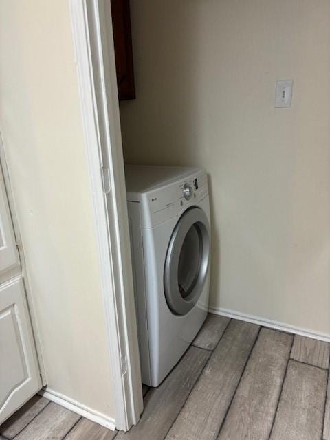 2413 Markland St, Irving, TX 75060 - clothes washing area featuring washer / clothes dryer, light wood-style floors, and baseboards