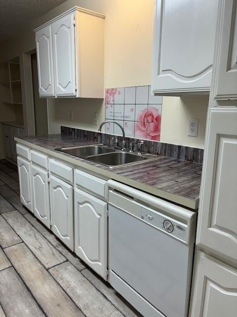 2413 Markland St, Irving, TX 75060 - kitchen with dishwasher, a sink, white cabinets, backsplash, and light wood-type flooring