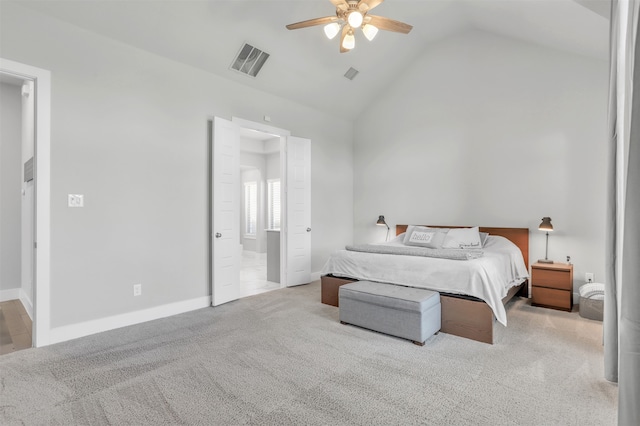 bedroom with vaulted ceiling, ensuite bath, ceiling fan, and light carpet