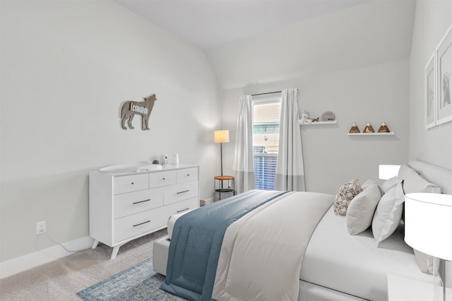 bedroom featuring light carpet and lofted ceiling