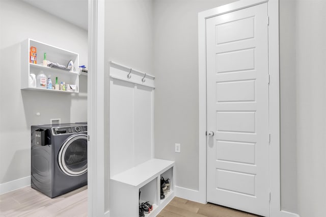 laundry room featuring light hardwood / wood-style flooring and washer / dryer