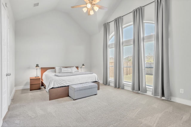 bedroom with ceiling fan, vaulted ceiling, and light carpet