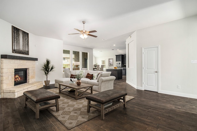 living room with ceiling fan, dark hardwood / wood-style flooring, and a fireplace