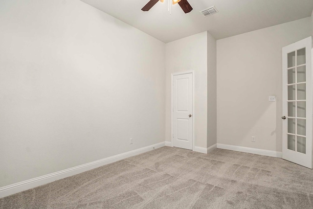 unfurnished room featuring light carpet and ceiling fan