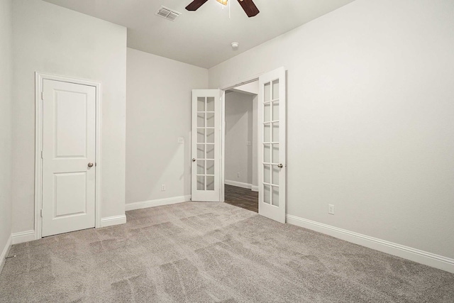 unfurnished bedroom with carpet flooring, ceiling fan, and french doors