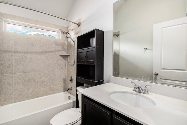 full bathroom featuring tiled shower / bath combo, toilet, and vanity